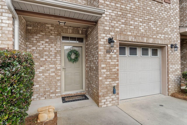 8872 White Ibis Way, Navarre, FL 32566 - entrance to property with brick siding, a garage, and concrete driveway