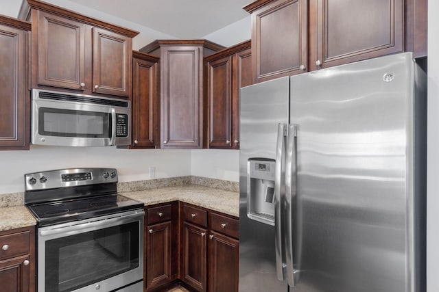 8872 White Ibis Way, Navarre, FL 32566 - kitchen featuring stainless steel appliances, light stone countertops, and dark brown cabinets
