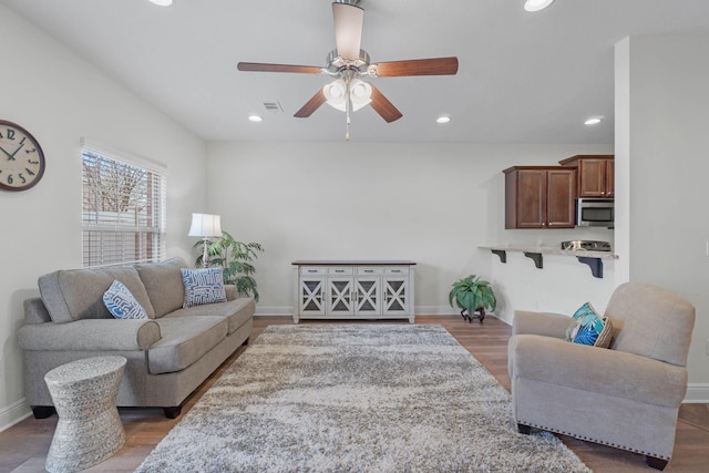 8872 White Ibis Way, Navarre, FL 32566 - living room featuring ceiling fan, visible vents, wood finished floors, baseboards, and recessed lighting