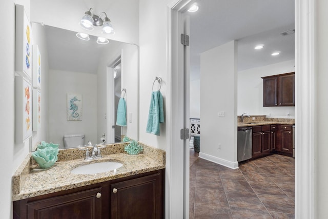 8872 White Ibis Way, Navarre, FL 32566 - bathroom with baseboards, vanity, toilet, and visible vents