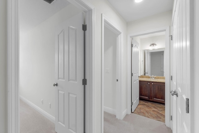 8872 White Ibis Way, Navarre, FL 32566 - hall featuring a sink, baseboards, and light colored carpet