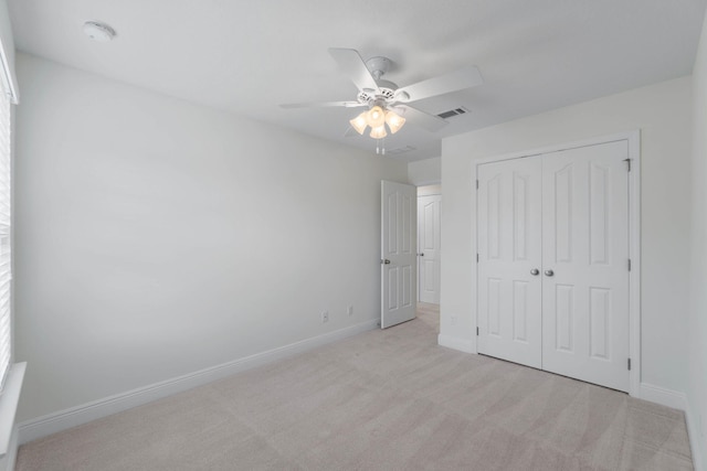 8872 White Ibis Way, Navarre, FL 32566 - unfurnished bedroom with a ceiling fan, light colored carpet, visible vents, baseboards, and a closet