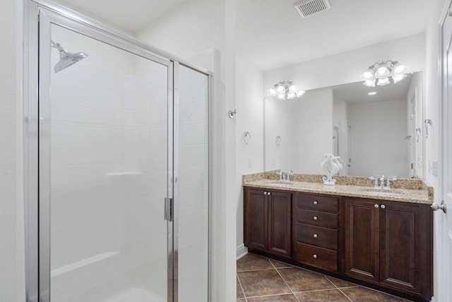 8872 White Ibis Way, Navarre, FL 32566 - bathroom with visible vents, a sink, a stall shower, and tile patterned flooring
