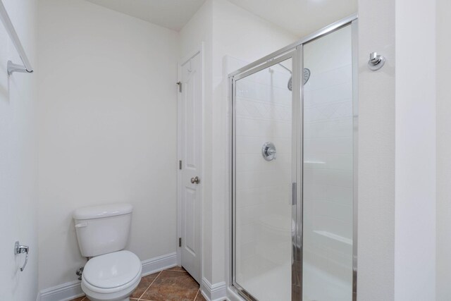 8872 White Ibis Way, Navarre, FL 32566 - bathroom featuring toilet, baseboards, and a shower stall