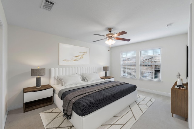 8872 White Ibis Way, Navarre, FL 32566 - bedroom featuring baseboards, light carpet, a ceiling fan, and visible vents