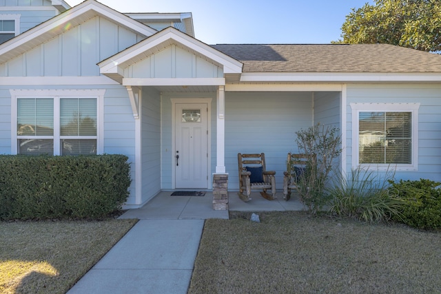 entrance to property featuring a yard and a porch