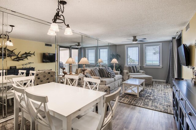 500 Gulf Shore Dr Unit 115B, Destin, FL 32541 - dining room featuring dark hardwood / wood-style flooring, a textured ceiling, and ceiling fan