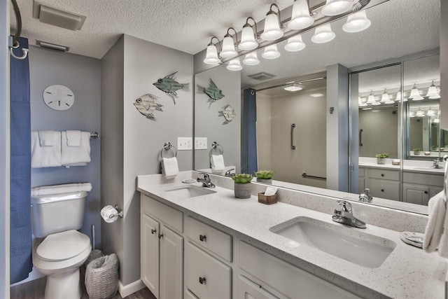 500 Gulf Shore Dr Unit 115B, Destin, FL 32541 - bathroom featuring vanity, toilet, and a textured ceiling
