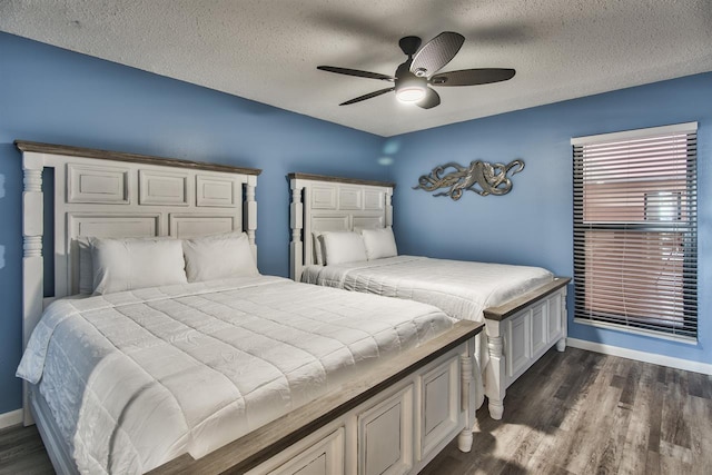 500 Gulf Shore Dr Unit 115B, Destin, FL 32541 - bedroom featuring ceiling fan, dark hardwood / wood-style flooring, and a textured ceiling