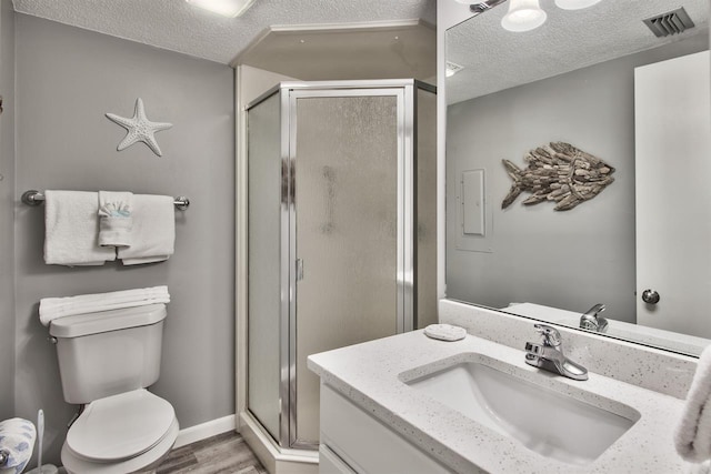 500 Gulf Shore Dr Unit 115B, Destin, FL 32541 - bathroom with vanity, toilet, a textured ceiling, and walk in shower