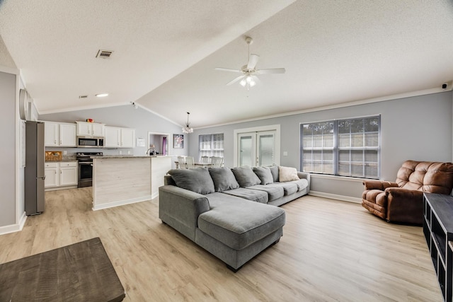 living room featuring lofted ceiling, crown molding, light hardwood / wood-style flooring, ceiling fan, and a textured ceiling