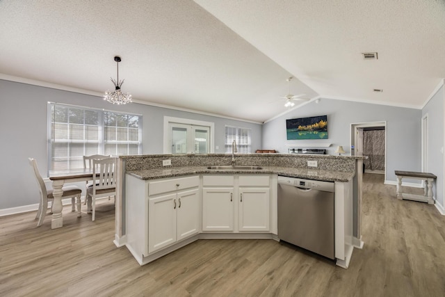 kitchen featuring sink, white cabinetry, decorative light fixtures, vaulted ceiling, and dishwasher