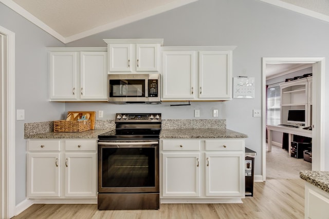 kitchen with lofted ceiling, white cabinetry, light stone counters, light wood-type flooring, and stainless steel appliances