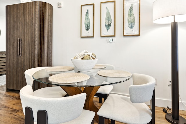 dining area with hardwood / wood-style floors