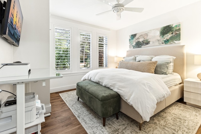 bedroom with dark hardwood / wood-style flooring and ceiling fan