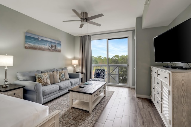 living room with wood-type flooring and ceiling fan