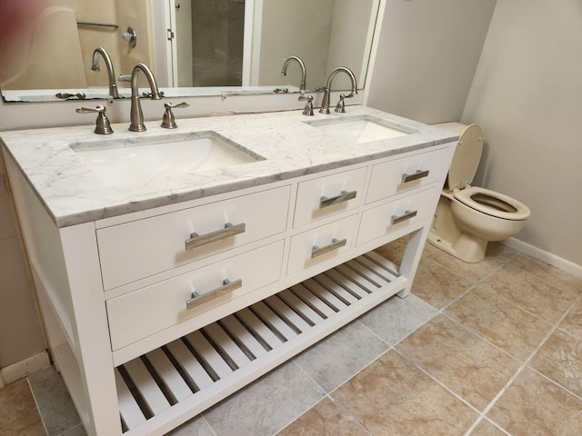 bathroom featuring vanity, tile patterned floors, and toilet