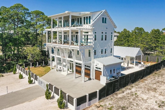 back of property with a garage and a balcony