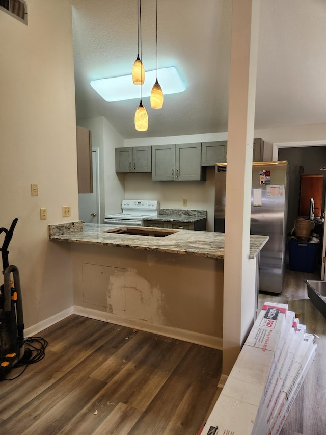 kitchen with decorative light fixtures, stainless steel fridge, white electric range oven, light stone counters, and dark wood-type flooring