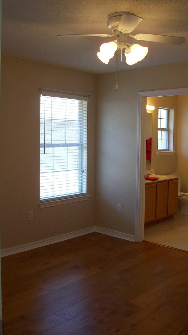 empty room featuring ceiling fan and dark hardwood / wood-style flooring