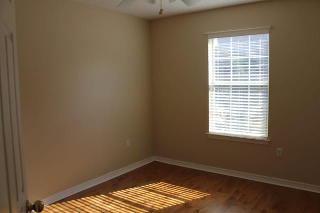 spare room with ceiling fan and dark hardwood / wood-style flooring