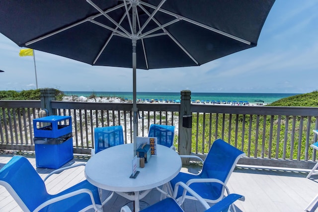 deck with a water view and a view of the beach