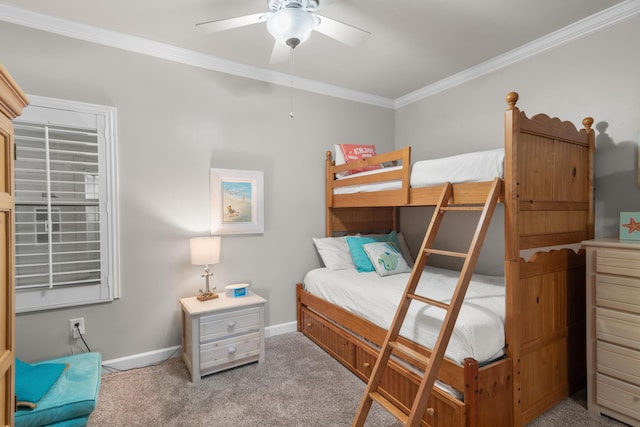 carpeted bedroom featuring ceiling fan and ornamental molding