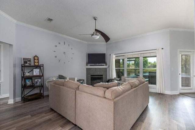 living room with crown molding, dark wood-type flooring, a textured ceiling, and ceiling fan