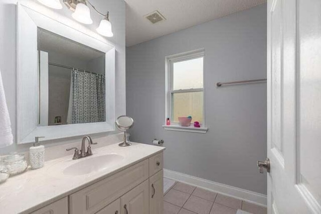 bathroom featuring vanity, curtained shower, and tile patterned floors