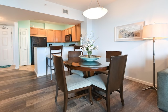 dining area with dark hardwood / wood-style flooring