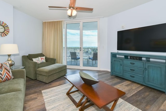 living room featuring ceiling fan and dark hardwood / wood-style floors