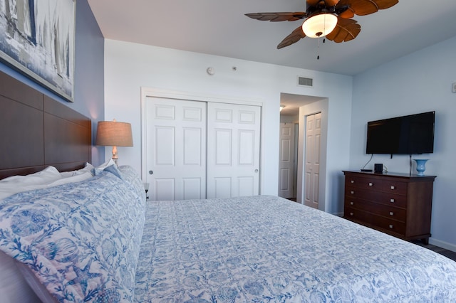 bedroom with ceiling fan and a closet