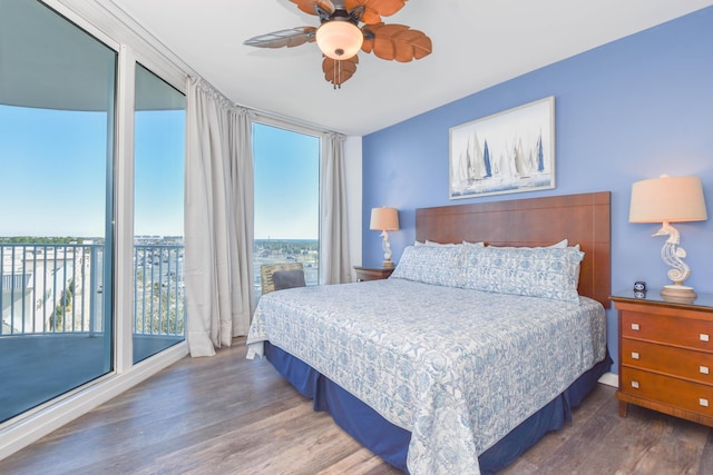 bedroom featuring dark wood-type flooring, ceiling fan, and access to outside