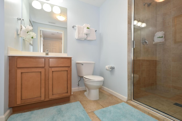 bathroom with tile patterned flooring, vanity, toilet, and walk in shower