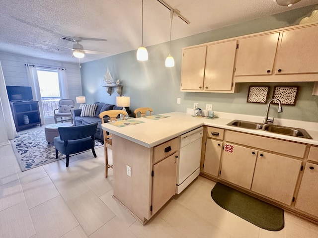 kitchen featuring sink, decorative light fixtures, dishwasher, kitchen peninsula, and ceiling fan