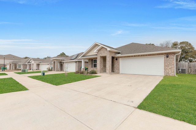 view of front of home with a garage, central AC, a front lawn, and solar panels