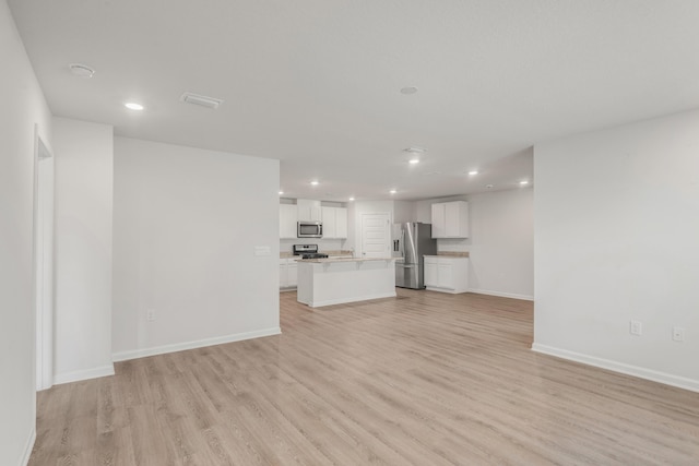 unfurnished living room with light hardwood / wood-style flooring