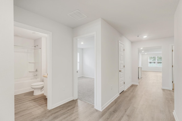 corridor with light hardwood / wood-style flooring