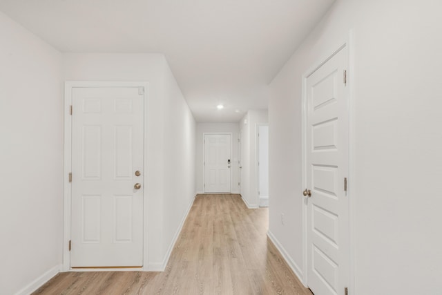 corridor with light hardwood / wood-style flooring