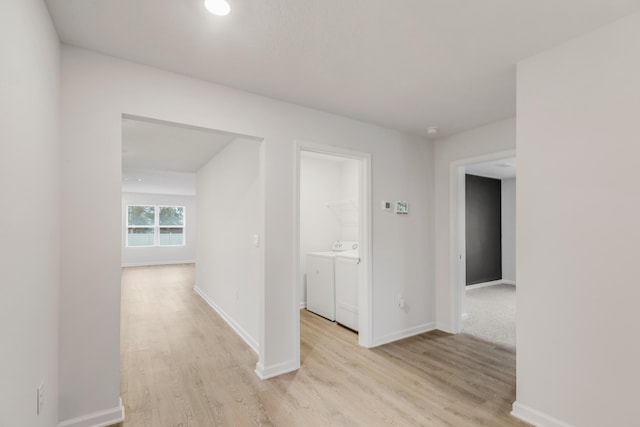 hall featuring separate washer and dryer and light hardwood / wood-style floors