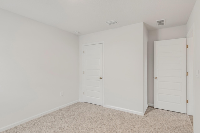 unfurnished bedroom with light colored carpet