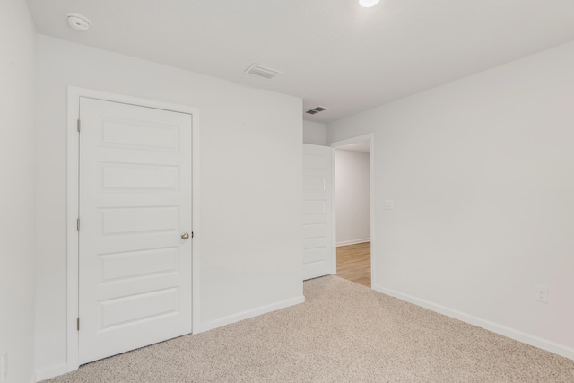 empty room featuring light colored carpet