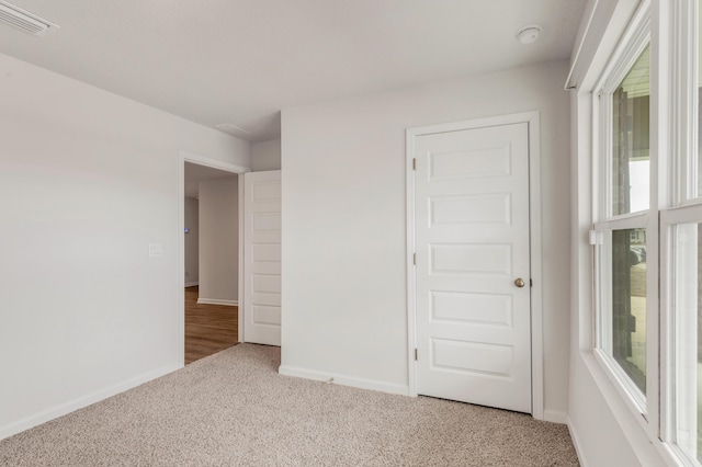 unfurnished bedroom with carpet floors