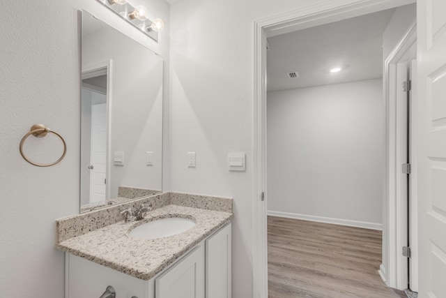 bathroom featuring vanity and wood-type flooring