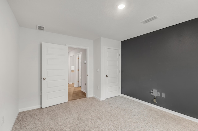 unfurnished bedroom featuring light colored carpet