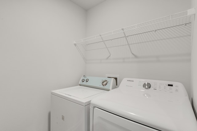 clothes washing area featuring separate washer and dryer