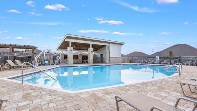 view of pool with ceiling fan and a patio