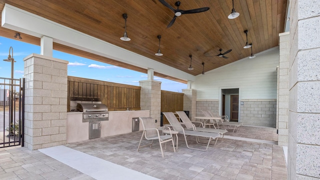view of patio / terrace featuring grilling area, ceiling fan, and an outdoor kitchen