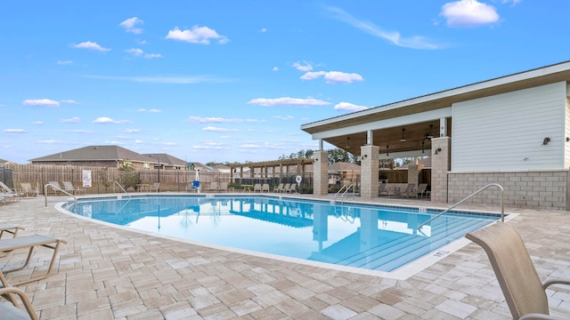 view of pool with a patio and ceiling fan