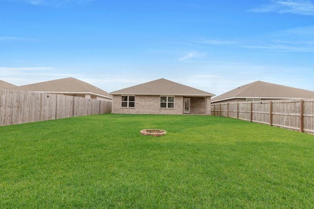 back of property featuring a lawn